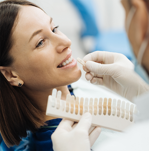 Woman having teeth shade matched for a metal-free restoration