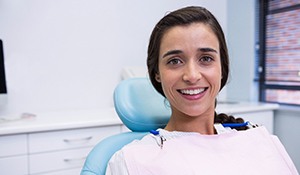 Young woman smiles after getting dental implants in Midland