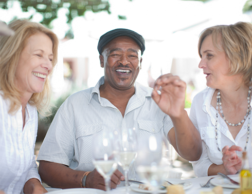 Three people enjoying meal at table