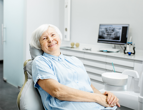 Senior woman in dental chair smiling