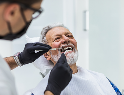 Man having teeth treated by dentist