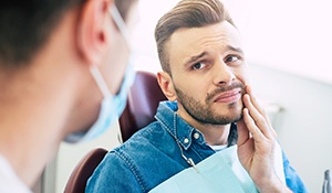 Man with toothache talking to emergency dentist in Midland