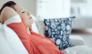 Relaxing woman with hands behind head