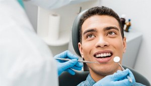 happy patient after having his teeth examined 