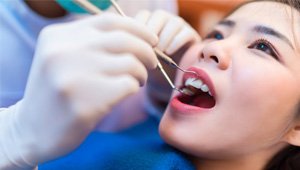 young woman admiring her dental implants in Odessa