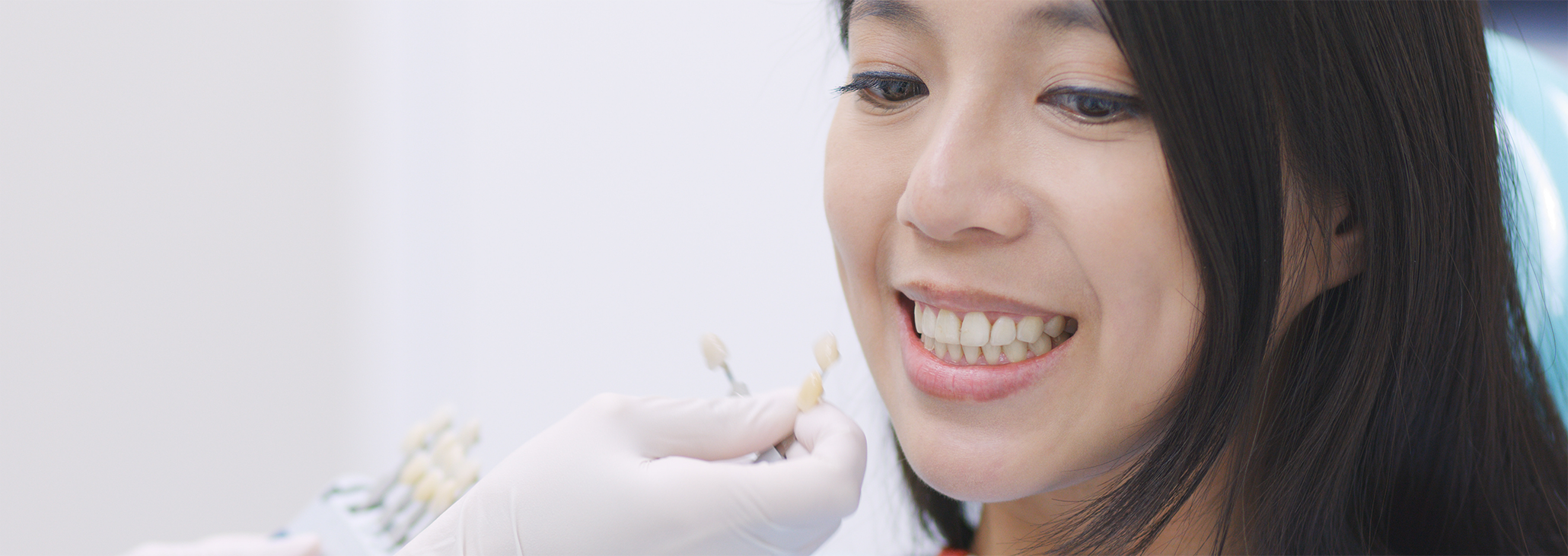 Woman having teeth shade matched for dental crowns in Midland