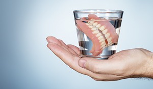 Storing dentures in water