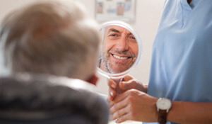 reflection in the mirror of a smiling patient