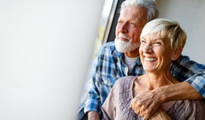 couple smiling and knowing the cost of dentures in Midland