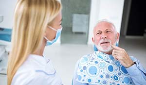 Patient speaking with a Midland emergency dentist