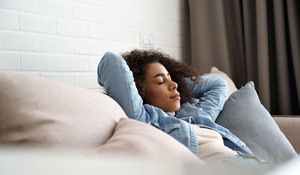 woman resting after a tooth extraction in Midland