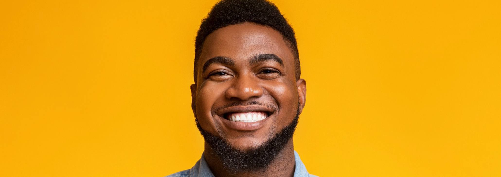 smiling person in front of a yellow background