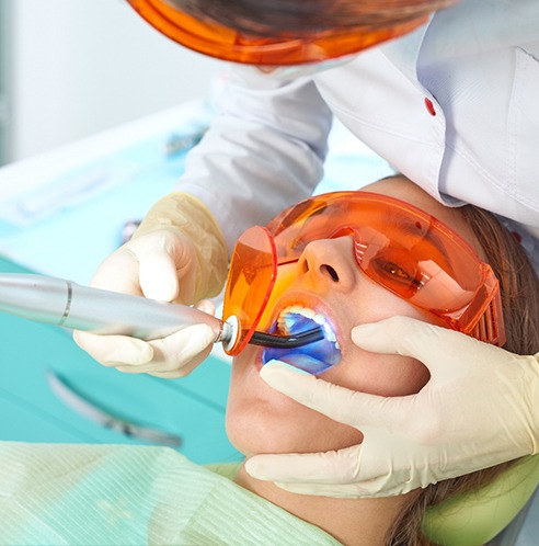 Patient getting the curing light to set her filling
