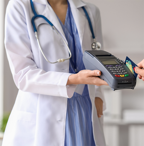 Holding up credit card reader for patient