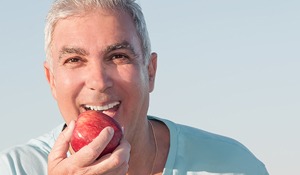 Mature man enjoying an apple