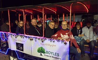 Midland dental team members sitting on bench at community event