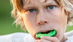 Teen boy placing sportsguard