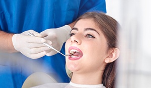 Woman receiving oral cancer screening