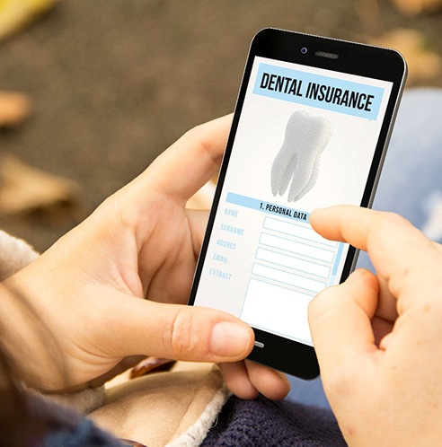 patient looks up dental insurance benefits on their phone