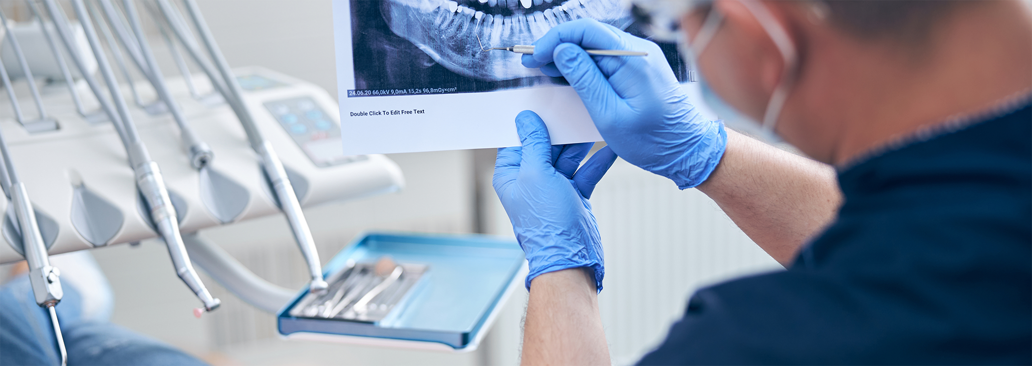 Dentist looking at a dental X-ray