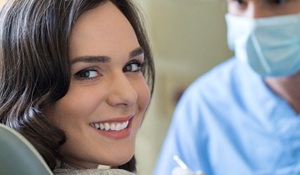 woman smiling with dentist after getting same-day crowns in Midland