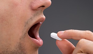 Man taking sedative pill