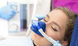 Woman in dental chair with nitrous oxide nasal mask