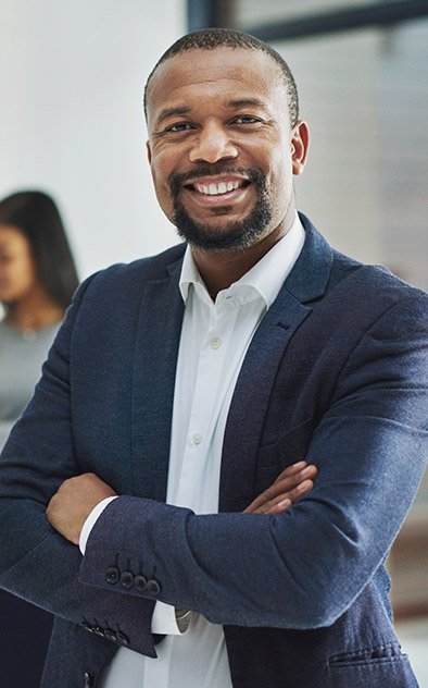 Man in business suit smiling with arms crossed