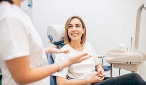 Woman smiling while talking to cosmetic dentist in Midland