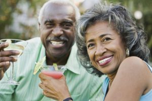 Happy mature couple enjoying a drink. 