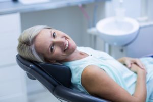 Smiling woman in the dental chair. 