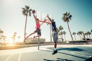 two men playing basketball wearing mouthguards