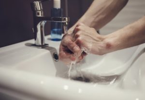 dentist washing their hands with antimicrobial soap