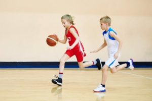 two children playing basketball