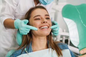 woman smiling after correcting small teeth