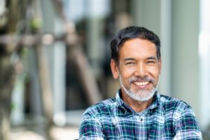 older man smiling outside