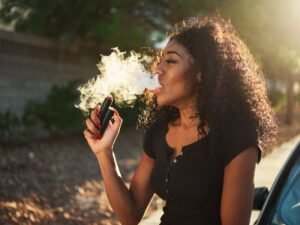 woman vaping with a plume of vaper around her