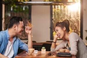 a couple laughing on a date at a restaurant