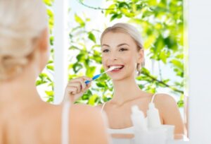 patient brushing with spring leaves in the background